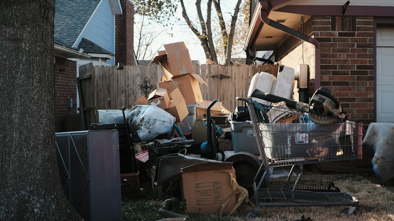 Bulky household items and boxes cleared from outside a house